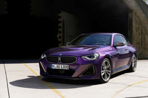 紫色BMW 2 Series Coupe停放在混凝土車庫中，陽光投射出銳利的陰影。 — Surface Pro 壁紙
