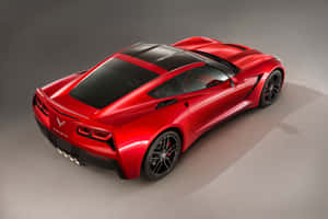 紅色Corvette跑車，黑色車頂和車輪，在工作室環境中。 — Surface Pro 壁紙