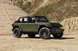 橄欖綠色Jeep Wrangler停在岩石結構附近的泥土上 — 吉普 壁紙