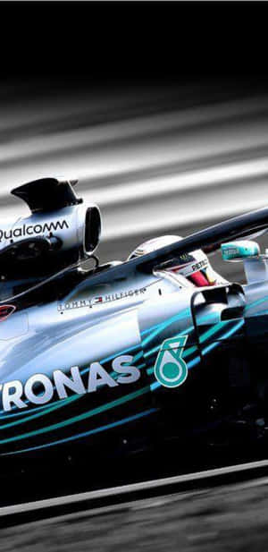 一輛賽車在賽道上高速行駛，帶有動態模糊效果。 — 賽車 壁紙