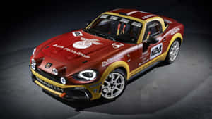 攝影棚中的紅色和金色 Abarth 124 賽車，帶有贊助商標誌和賽車貼紙。 — 白色法拉利 壁紙