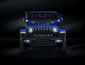 在黑暗的攝影棚環境中，藍色Jeep Wrangler車頭燈亮起。 — 吉普 壁紙