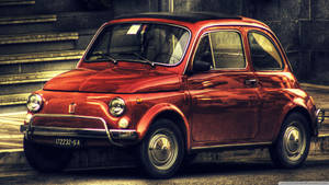 復古紅色Fiat 500停泊在石階附近的城市街道上。 — 白色法拉利 壁紙