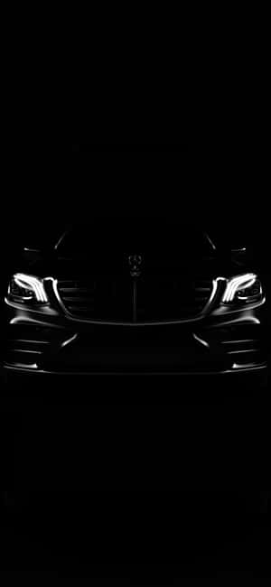 時尚的梅賽德斯-奔馳汽車前部，在黑暗中帶有發光的車頭燈。 — Mercedes Benz C300 壁紙