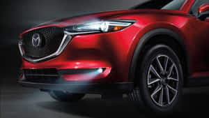 紅色Mazda SUV正面視圖，帶有發光頭燈和合金輪圈。 — 馬自達 壁紙
