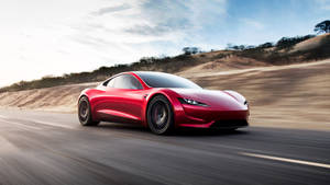 紅色Tesla Roadster在日落時分的沙漠公路上疾馳。 — 特斯拉 壁紙