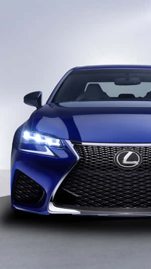 藍色Lexus汽車前部的特寫，在工作室環境中頭燈亮起。 — 凌志 壁紙