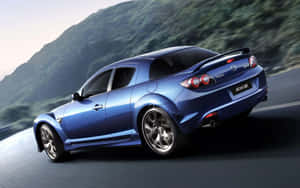 藍色馬自達RX-8在日落時分的山路上疾馳。 — 馬自達 壁紙