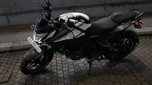 夜間停在磚砌路面上的黑白機車。 — 改裝摩托車 壁紙