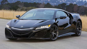 黑色Acura NSX跑車停放在靠近草坡的道路上。 — 低調 壁紙