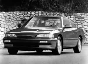 一輛黑色Acura轎跑車停在石牆前。 — Acura 壁紙