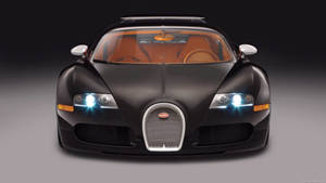 黑色Bugatti Veyron的正面視圖，帶有橙色內飾和發光頭燈。 — 好看汽車 壁紙