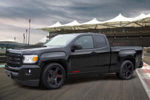 黑色GMC Sierra AT4皮卡車在賽道上，帶有紅色點綴，在暴風雨的天空下。 — Toyota Supra Mk4 壁紙