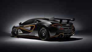 黑色McLaren賽車，帶有橙色飾邊和號碼59，在攝影棚燈光下。 — 麥拉倫 壁紙