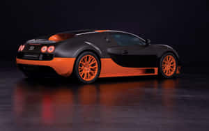 攝影棚內反光地板上的黑色和橙色Bugatti Super Sport跑車。 — 布加迪 GIF 壁紙