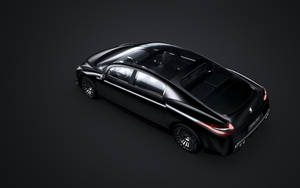 一輛黑色豪華轎車，在黑暗工作室中帶有發光的尾燈。 — Mercedes Benz C300 壁紙