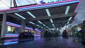 黑色跑車在夜雨中停放在發光的加油站下。 — 極速快感熱焰 壁紙