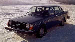 深藍色富豪244DL轎車停放在雪地上，陽光普照。 — Mercedes Benz C300 壁紙