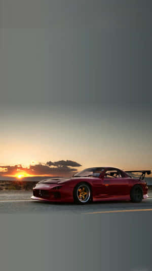 紅色Mazda RX-7跑車停泊在日落時分的沙漠道路上。 — 日落 壁紙