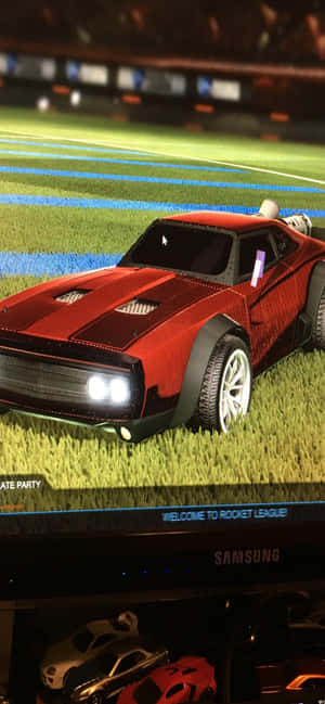體育場綠色場地上的紅色Rocket League賽車。 — Galaxy S26 壁紙
