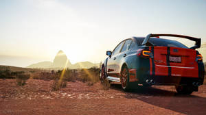 紅色和藍色的Subaru WRX STI停在日落時分的沙漠公路上。 — 極限競速 地平線 4 壁紙
