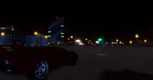 紅色跑車在夜間停泊在一條黑暗的海濱道路上，有發光的街燈。 — 海灘 壁紙