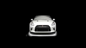白色日產GT-R跑車在黑色背景下照亮。 — 日產GTR 壁紙