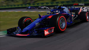 藍紅色的Red Bull Formula 1賽車在賽道上疾馳，帶有動態模糊效果。 — F1 2019 壁紙