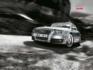 銀色 Audi 房車在山路上行駛，帶動態模糊效果。 — 奧迪 GIF 壁紙