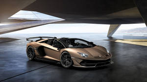 青銅色藍寶堅尼Aventador SVJ Roadster停放在海邊的現代混凝土建築下。 — 4K 藍寶堅尼 壁紙