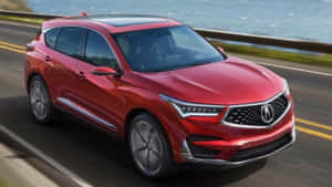 紅色Acura SUV在靠近海洋的海岸公路上行駛 — Acura 壁紙