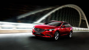 紅色Mazda6旅行車在夜間於燈光拱橋下疾馳。 — 馬自達 壁紙