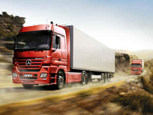 兩輛紅色卡車在塵土飛揚的山路上疾馳。 — 卡車 壁紙
