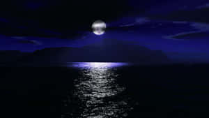 滿月映照在平靜的海面上，山巒剪影襯托著深紫色的天空。 — 月夜星空 壁紙