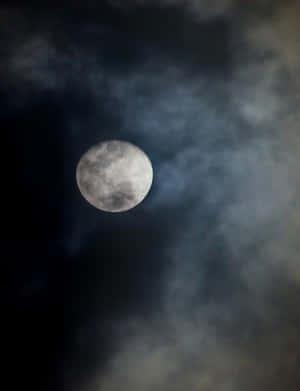 滿月穿過夜間黑暗的暴風雲照耀。 — 夜空 壁紙