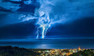 夜晚海岸城市附近海洋上空的閃電。