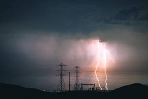 閃電照亮了黑暗暴風雨天空下的電線。 — 閃電麥坤 壁紙