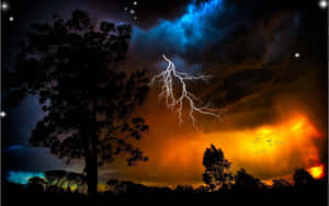 夜晚暴風雨的天空下，剪影樹木伴隨著閃電和火紅的雲朵。 — 閃電 壁紙