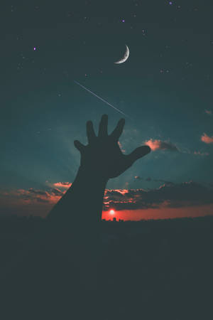 暮色中伸向新月和流星的手部剪影。 — 月光 壁紙