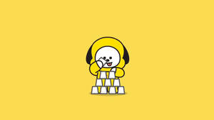 一隻卡通狗在黃色背景上堆疊白色積木。 — 奇米 BT21 壁紙