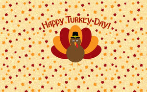 戴著朝聖者帽子的卡通火雞被秋葉環繞，附有Happy Turkey Day文字。 — 16:10 壁紙