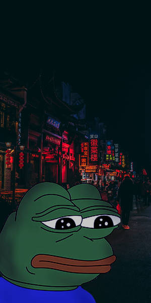 悲傷的綠色卡通青蛙在夜晚霓虹燈中國街道前。 — 科米蛙 壁紙