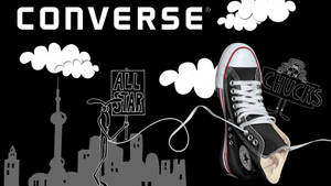 黑色Converse運動鞋，卡通人物在城市天際線上方舉著標語牌。 — Converse 標誌 壁紙