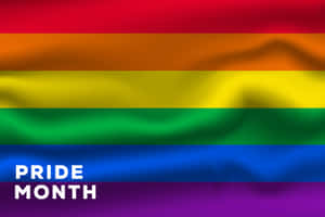 帶有「PRIDE MONTH」文字的彩虹驕傲旗，慶祝 LGBTQ+ 社群。 — MacBook Air 13 壁紙