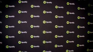 牆壁覆蓋著重複的綠色和白色Spotify標誌。 — 簡約暗黑美學 壁紙