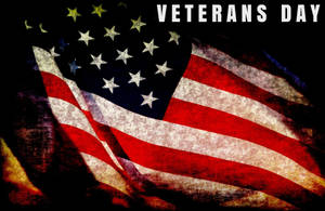 磨損的美國國旗，帶有「Veterans Day」文字，向軍事服務致敬。 — 退伍軍人節 壁紙