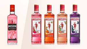 五款不同水果口味的Beefeater琴酒瓶排成一列展示。 — 橘色 壁紙