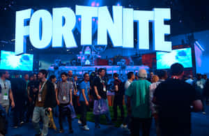 在明亮的藍色標誌下參加Fortnite遊戲活動的與會者。 — MacBook Air 壁紙