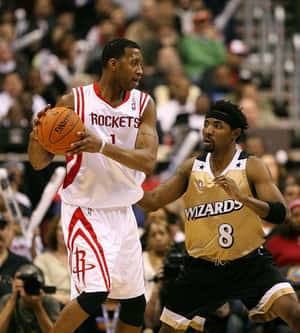 兩名籃球運動員在NBA比賽中行動，一人運球，另一人防守。 — 榮耀Magic V 壁紙