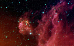 在深空中，一個發光的紅色和藍綠色星雲充滿了明亮的星星。 — 2880x1800 壁紙